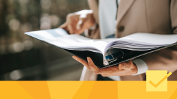 Banner for What is Peer Review article showing a person reading a binder of notes.