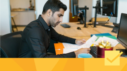 A man working on submission guidelines on a computer.