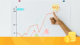 A person giving a thumbs up as they review the profits from revenue models