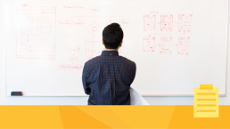 A man standing in front of a whiteboard examining the hidden costs of manual workflow processes.