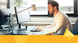 A man sitting at a computer reading the freemium changes to JAMS.