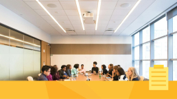 An international board convening around a table for a meeting.
