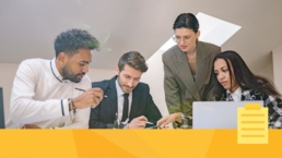 A group of employees discussing how best to organize journal submissions.